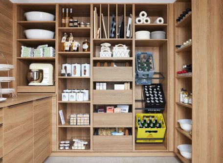 A natural wood pantry with neatly organised dry food goods