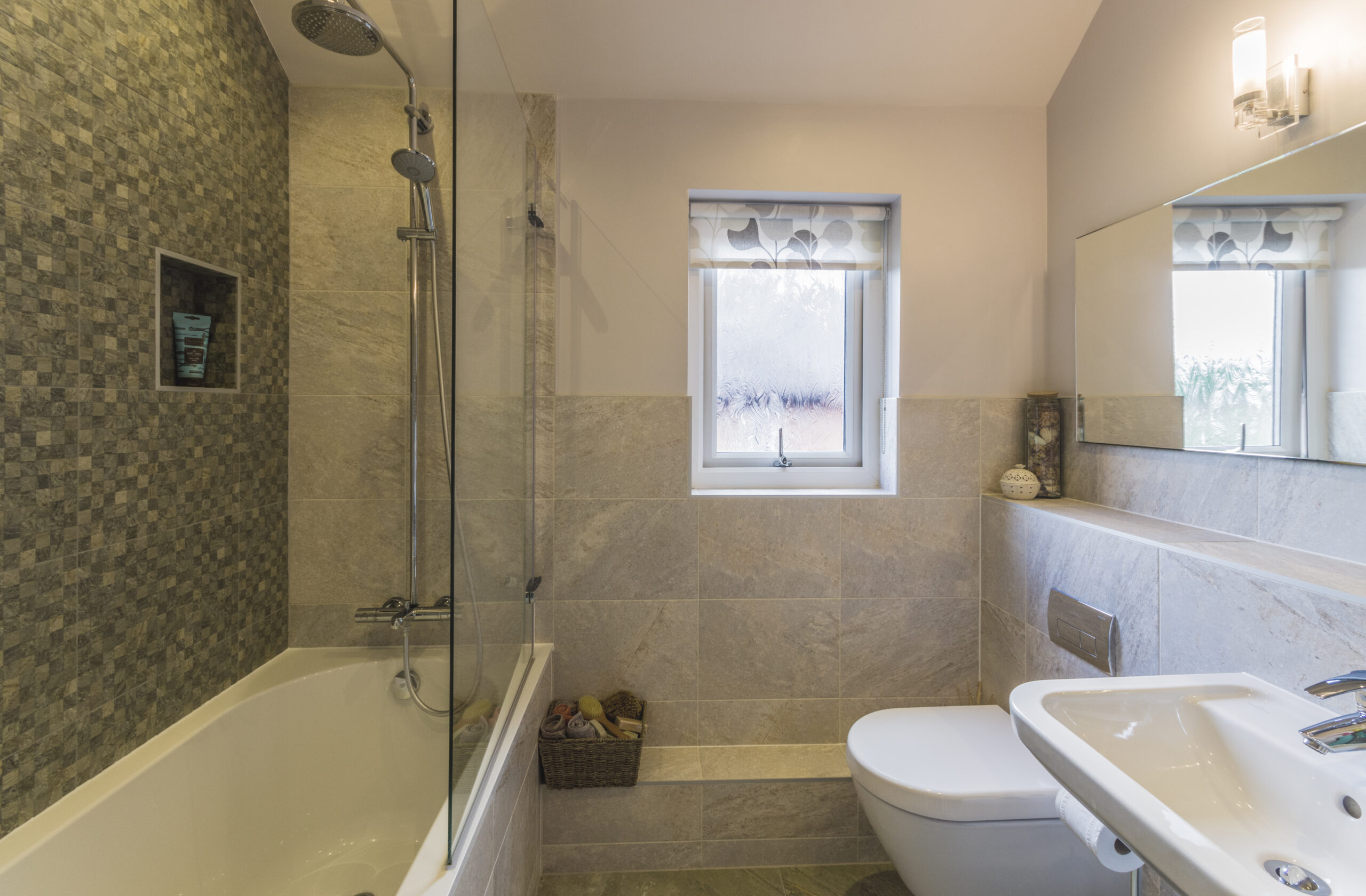 Grey tiled family bathroom